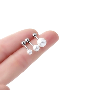 Three sizes of classic pearl stud earrings in titanium steel shown held between fingers