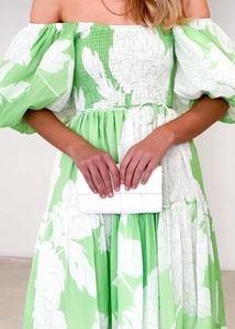 Detail of floral off-shoulder dress with smocking and white woven texture clutch bag