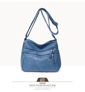 Detail view of lake blue washed PU leather bag showing three front zipper pockets
