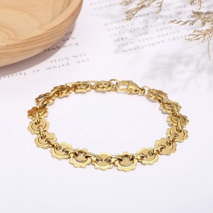 Titanium steel bracelet featuring golden sun gear links with minimalist smiley face charms