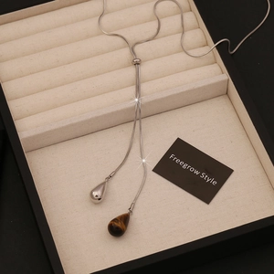 Long Y-shaped snake chain necklace featuring metal and tiger eye stone water drop pendants
