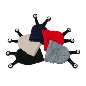 Knit beanie with monster eyes tentacles in various colors like red and navy blue