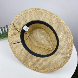 Internal view showing 100% paper material label and sweatband of the straw hat