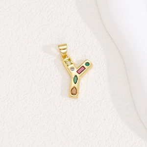 Detailed view of letter Y pendant with multicolor zircon stones and gold finish