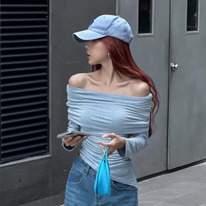Close-up of gray-blue off-shoulder top featuring ruching and asymmetric hem detail