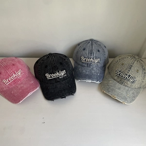 Close-up of four washed distressed denim baseball caps with Brooklyn 3D embroidery detail