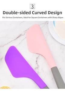 Detail of pink and purple silicone spatulas with dual-sided edges on marble surface