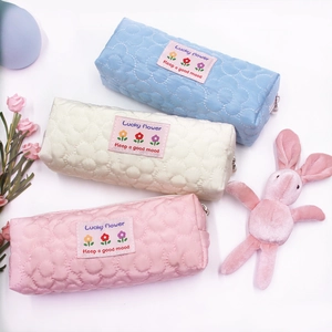 Quilted floral pencil cases in pink, white, and blue with Lucky Flower embroidery