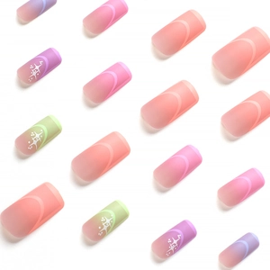 Matte gradient press-on nails with star patterns in pink, purple, and green colors