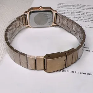 Detail shot of rose gold rectangular watch on magazine showing band and case back