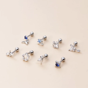 Detailed set of silver stud earrings with blue and white crystals in butterfly and star shapes