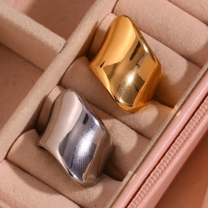 Chunky gold and silver irregular geometric rings displayed in a pink velvet jewelry box
