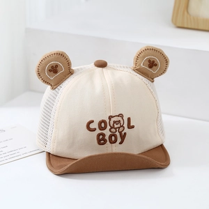 Macro detail of breathable mesh baby sun hat with cool boy text and cute bear ears