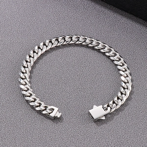 Close-up of silver stainless steel Cuban chain bracelet with secure square clasp