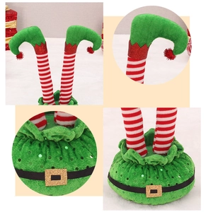 Close-up of Christmas elf legs with red and white stripes, gold buckles and sequins