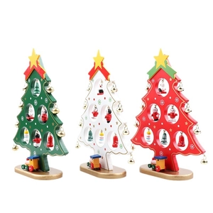 Three mini wooden Christmas trees with bells and small trains for holiday table decor