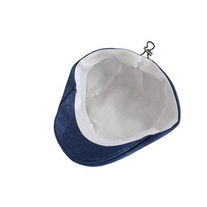 Inside view of denim beret featuring breathable white lining and adjustable elastic cord