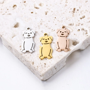 Macro view of cartoon dog charms in silver, gold, and rose gold polished finishes
