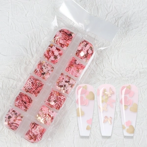 Pink heart and butterfly nail art sequins in a 12-grid storage box for DIY manicure