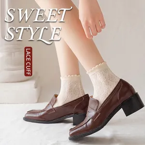 Beige cotton lace socks with hollow diamond pattern worn with brown leather shoes