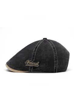 Side view of washed grey denim flat cap featuring vintage Natural embroidery patch