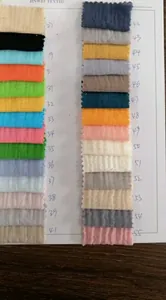 Macro view of assorted colorful muslin cotton gauze fabric swatches with crinkle texture