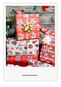 Close-up of vibrant Christmas gift wrapping paper featuring Santa and snowman patterns