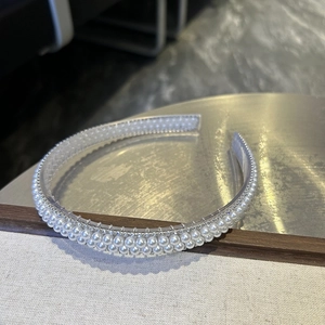 Detail of baroque crystal headband with double-row pearls and rhinestones on silver base