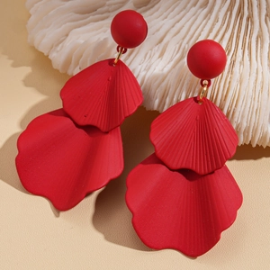 Macro shot of red petal earrings with matte texture and elegant gold link detail
