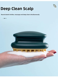Detail of dark green silicone scalp massager brush with yellow elastic bristles in foam