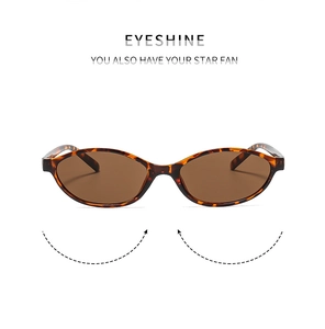 Detail of vintage oval tortoise shell sunglasses with premium brown lenses and metal hinges