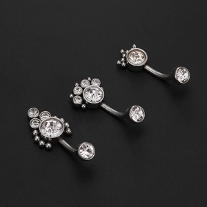Three silver belly bars with sparkling paw print zircon designs on grey background