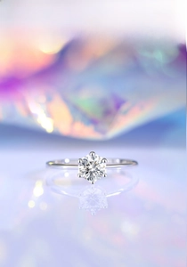 Detailed macro view of 0.5ct moissanite round cut in a classic six-prong silver setting