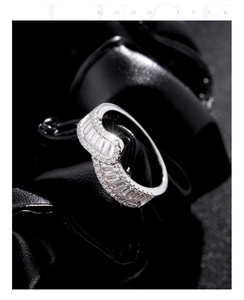 Macro view of s925 silver ring with emerald cut crystal and crossover diamond band