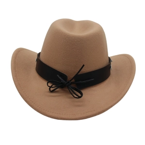 Close-up of classic western cowboy hat with brown felt texture and black leather hatband
