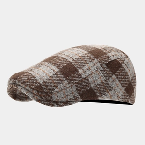 Detailed macro view of the brown grey plaid pattern on this wool flat cap for men and women