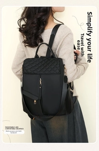 Detail showing the quilted diamond pattern and golden zipper on black nylon backpack