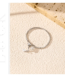 Macro detail of S925 sterling silver chain ring with heart charm and VVS1 moissanite