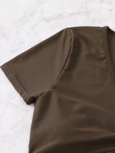 Close-up of the professional stitching and smooth fabric on the brown bikini top
