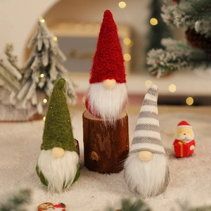 Set of three knitted Christmas gnomes with wooden bases for festive holiday tabletop decor