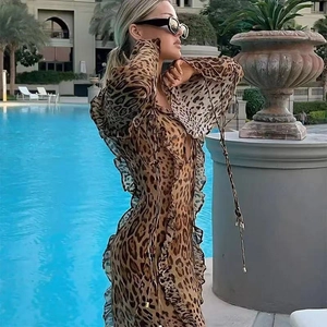 Detail of leopard print chiffon dress featuring ruffles and a chic front slit design