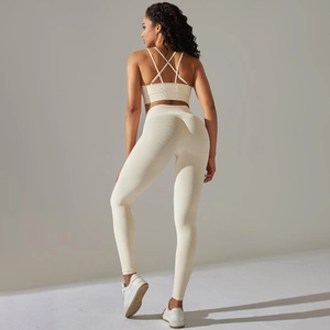 Detail of cross-back sports bra and ribbed high-waisted leggings in beige yoga set