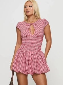 Detail of red and white plaid dress with smocked waist and tie-up front cutout