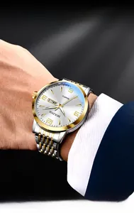 Detail of silver-gold stainless steel watch with white dial and day-date calendar display