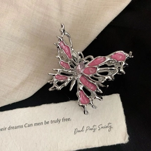 Close-up of liquid metal butterfly hair claw with pink enamel and marquise zircon