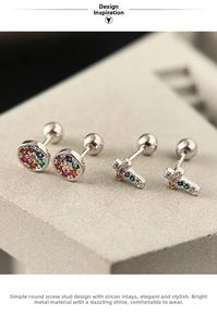 Macro detail of 925 silver screw back earrings with colorful zircon cross and round studs