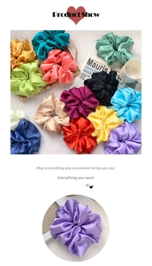 Detail of colorful satin scrunchies featuring high-gloss fabric and pleated texture design
