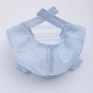 Detail of adjustable velcro strap and striped cotton fabric on newborn sun hat