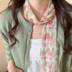 Pastoral floral mesh scarf necklace on model wearing a green cardigan and white top