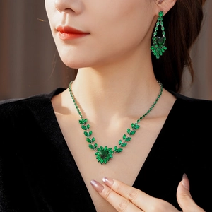 Close-up of model wearing luxury green heart gemstone necklace and ear studs jewelry set